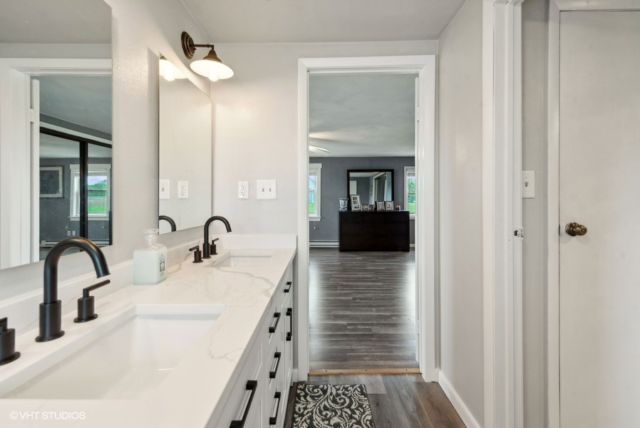 11719 Engelhardt Road Harvard, IL 60033 - Photo 10 of 18 a bathroom with a sink and a mirror