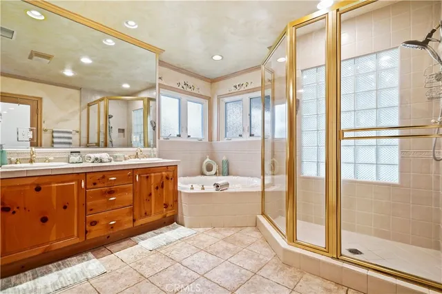 a spacious bathroom with a double vanity sink mirror and shower