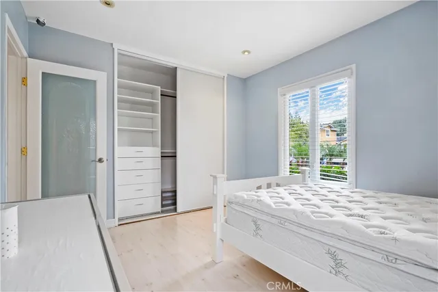 a bedroom with a bed and walk in closet