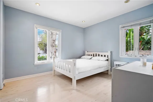 a bed sitting in a bedroom next to a window