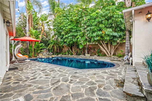 a view of a backyard with plants and a patio