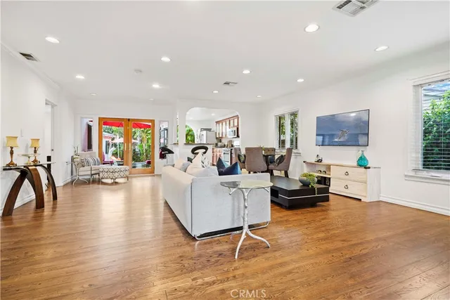 a living room with furniture and a wooden floor