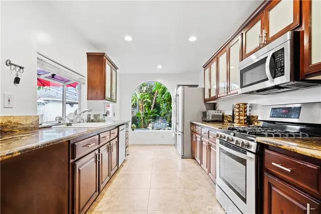 a kitchen with stainless steel appliances granite countertop a stove and a sink