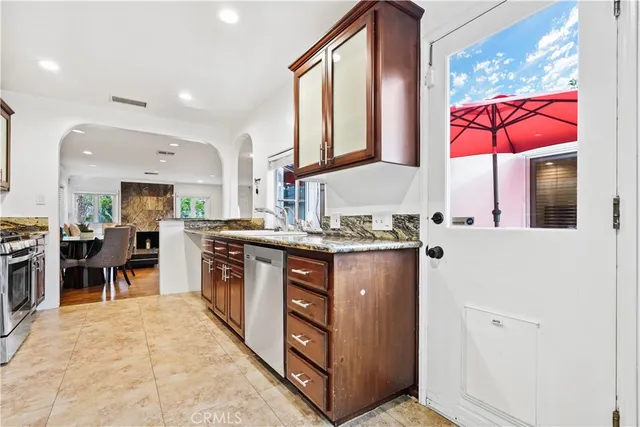 a kitchen with stainless steel appliances granite countertop a stove and a sink