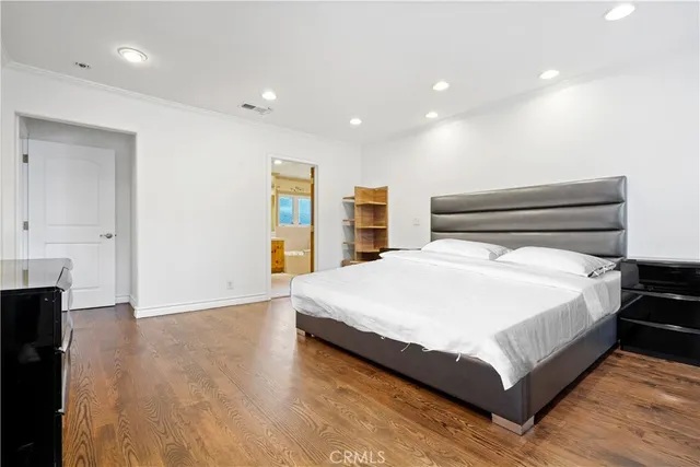 a large white bed in a white room
