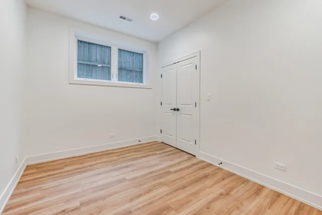 a view of a room with wooden floor and white walls