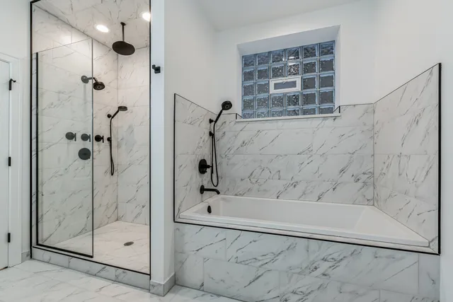 a bathroom with a glass shower door