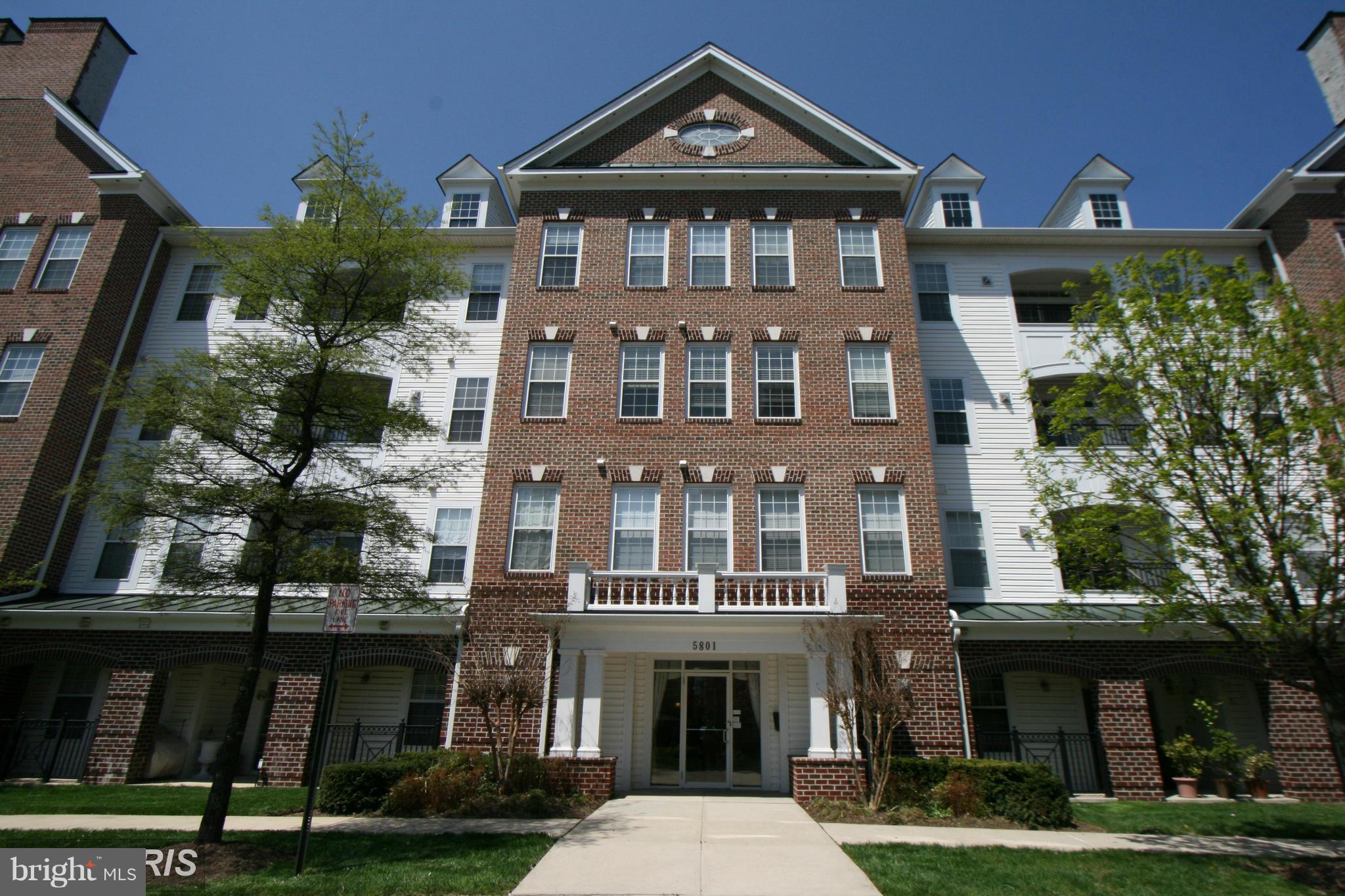 a front view of a residential apartment building with a yard