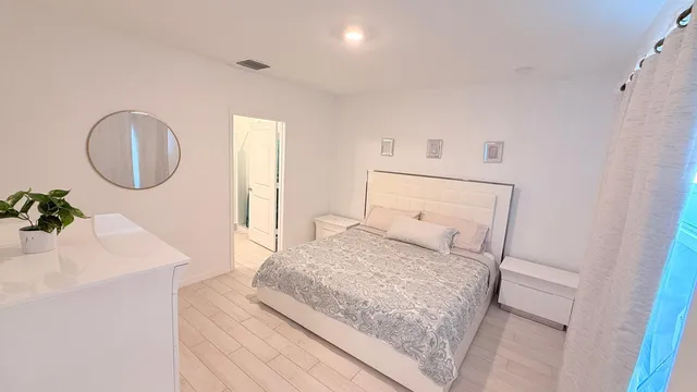 a bathroom with a double vanity sink a mirror and a shower