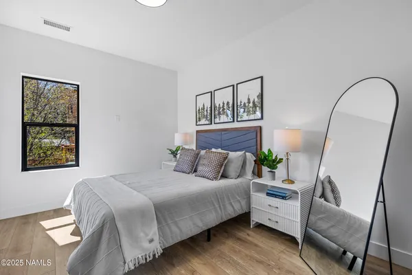 a bedroom with a bed a couch and dresser