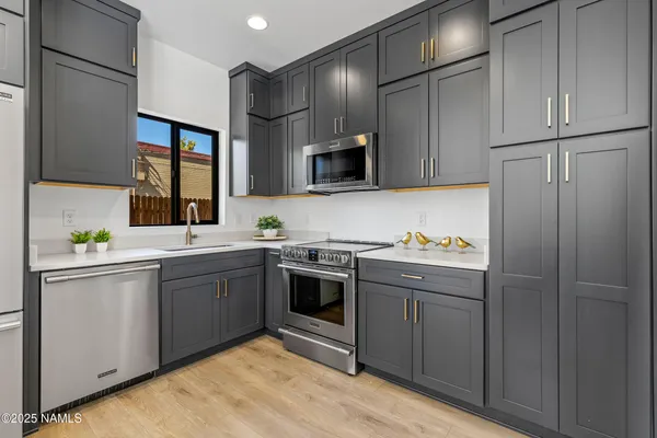 a kitchen with stainless steel appliances granite countertop a stove and a refrigerator