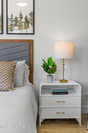 a bedroom with a bed and a painting on the wall