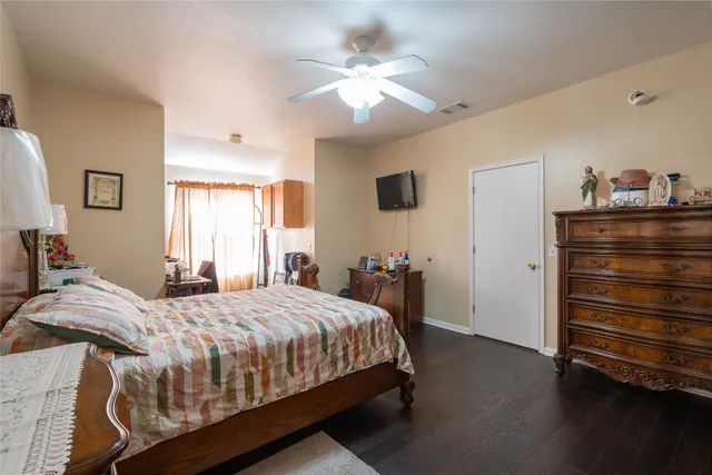 a bathroom with double vanity sinks a large mirror and a bathtub