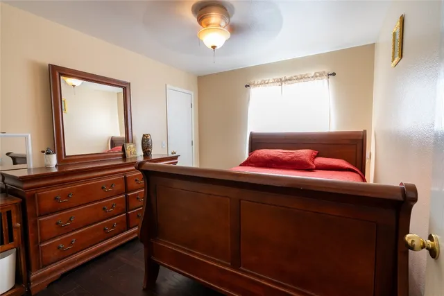 a bedroom with a bed window and flat screen tv