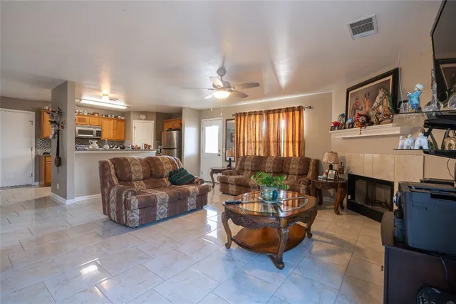 a living room with fireplace furniture and a window