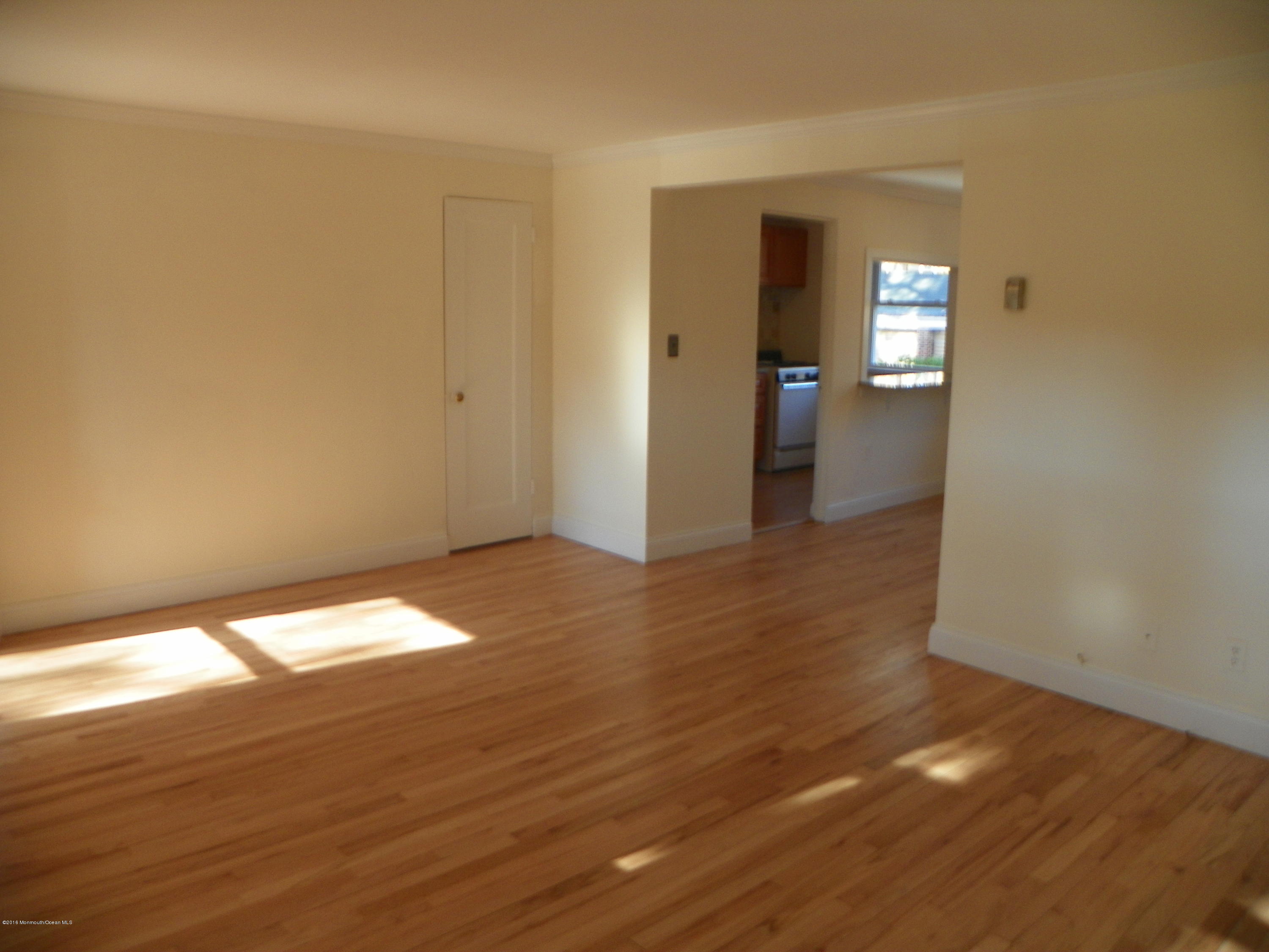 6 Manor Drive Red Bank, NJ 07701 - Photo 2 of 13 wooden floor in an empty room with a window