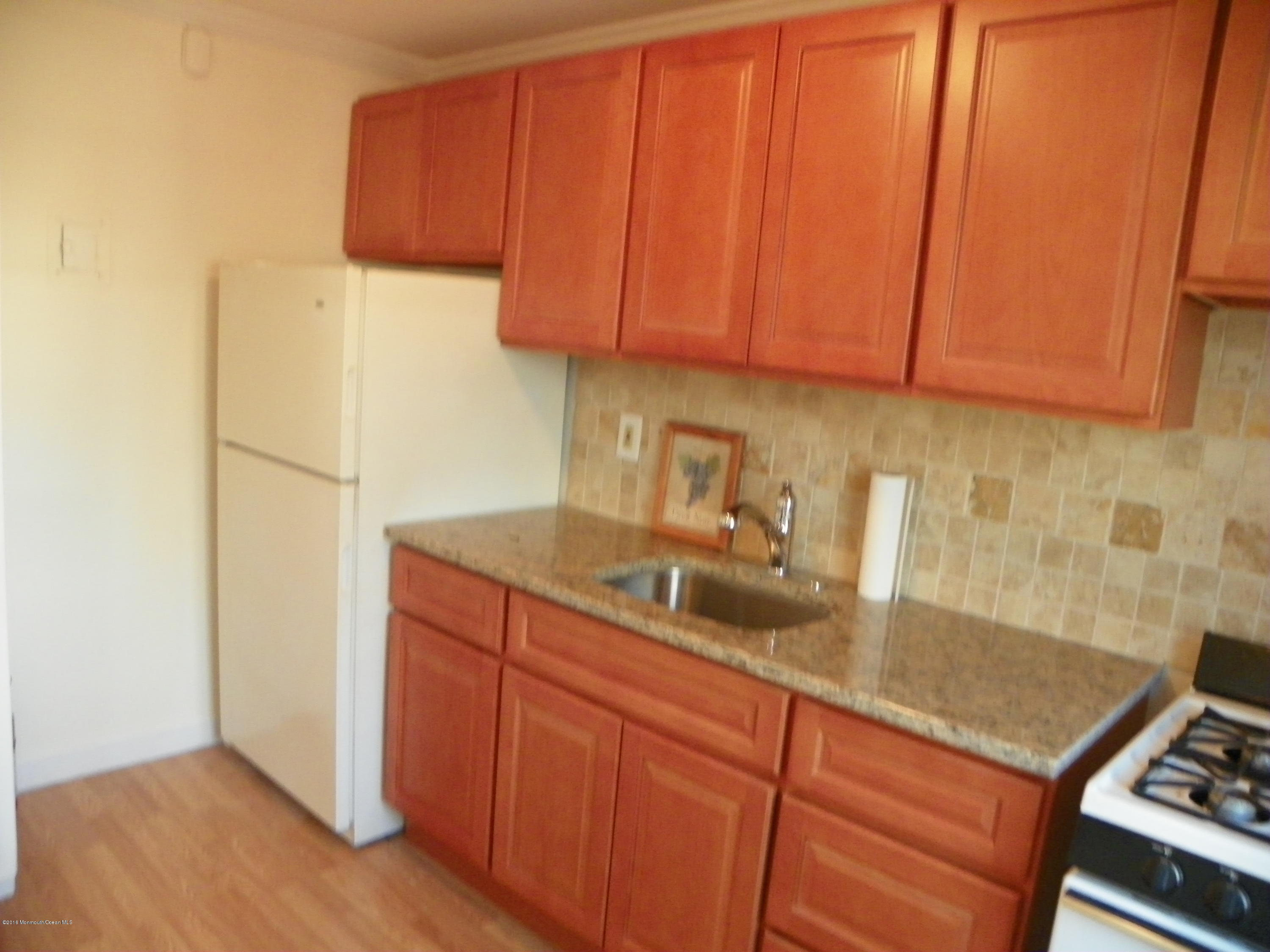 6 Manor Drive Red Bank, NJ 07701 - Photo 3 of 13 a kitchen with stainless steel appliances granite countertop a sink stove and refrigerator