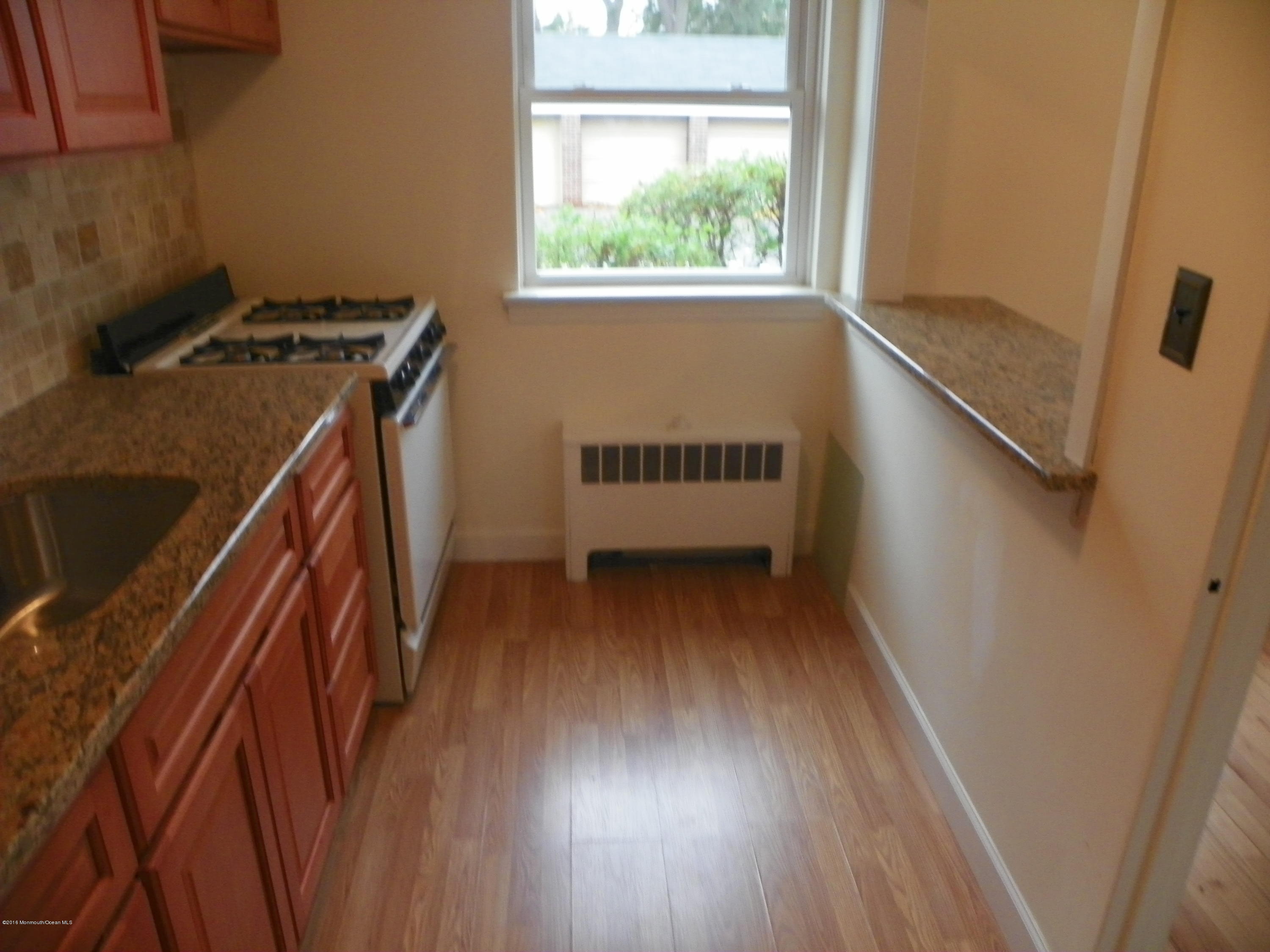 6 Manor Drive Red Bank, NJ 07701 - Photo 4 of 13 a view of an empty room with wooden floor and a window