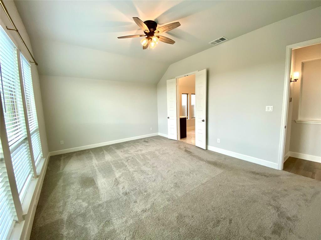 1937 Halkin Road Celina, TX 75009 - Photo 9 of 20 Primary bedroom featuring vaulted ceilings, a ceiling fan with integrated lighting, and light gray wall paint