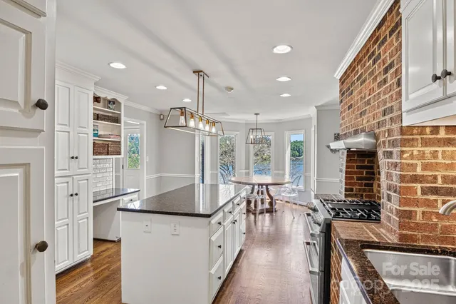 a kitchen with stainless steel appliances granite countertop a stove and a refrigerator