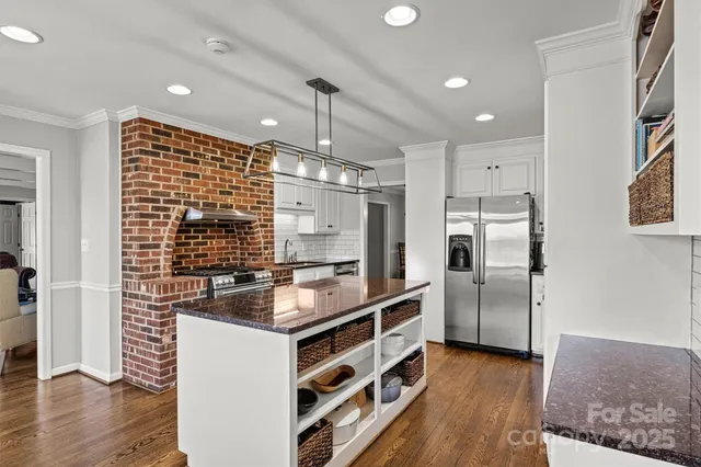a kitchen with cabinets and stainless steel appliances