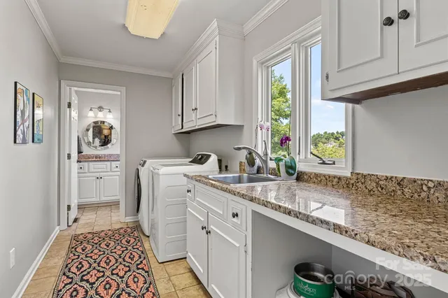 a kitchen with a sink window and cabinets