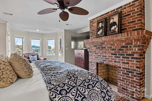 a spacious bedroom with a bed and a fireplace