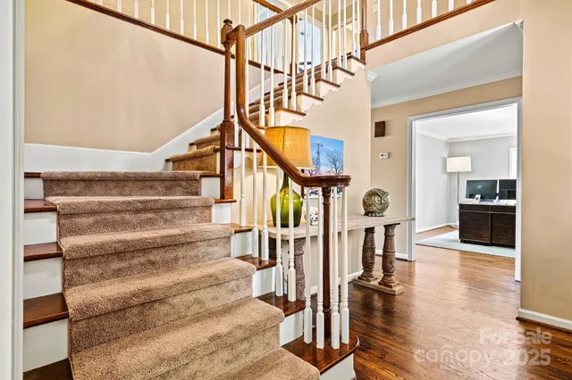 a view of entryway and hall with wooden floor