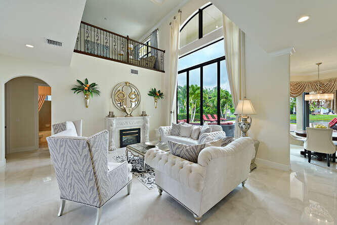 6950 Northwest 26th Way Boca Raton, FL 33496 - Photo 3 of 16 a living room with furniture a fireplace and a large window