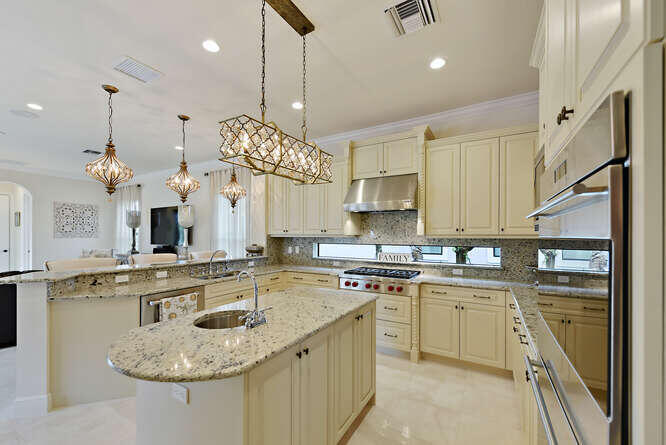 6950 Northwest 26th Way Boca Raton, FL 33496 - Photo 5 of 16 a kitchen with stainless steel appliances granite countertop a sink a stove and a refrigerator