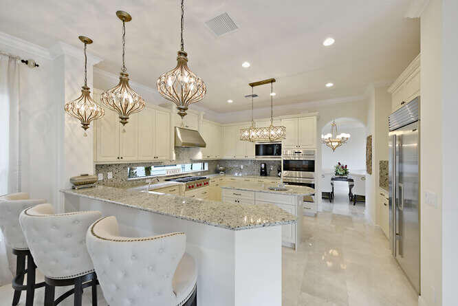 6950 Northwest 26th Way Boca Raton, FL 33496 - Photo 6 of 16 a view of a dining room and chandelier