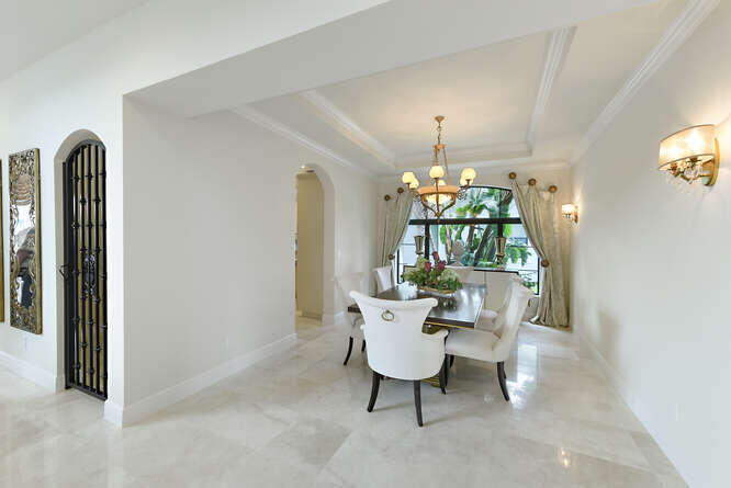 6950 Northwest 26th Way Boca Raton, FL 33496 - Photo 7 of 16 a dining room with furniture a chandelier and window