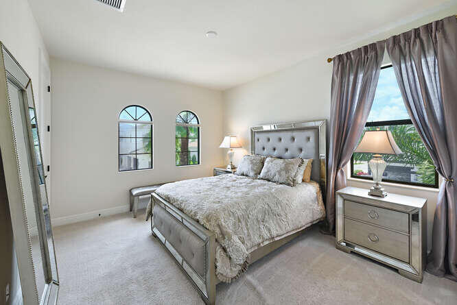 6950 Northwest 26th Way Boca Raton, FL 33496 - Photo 10 of 16 a bedroom with a bed and a window