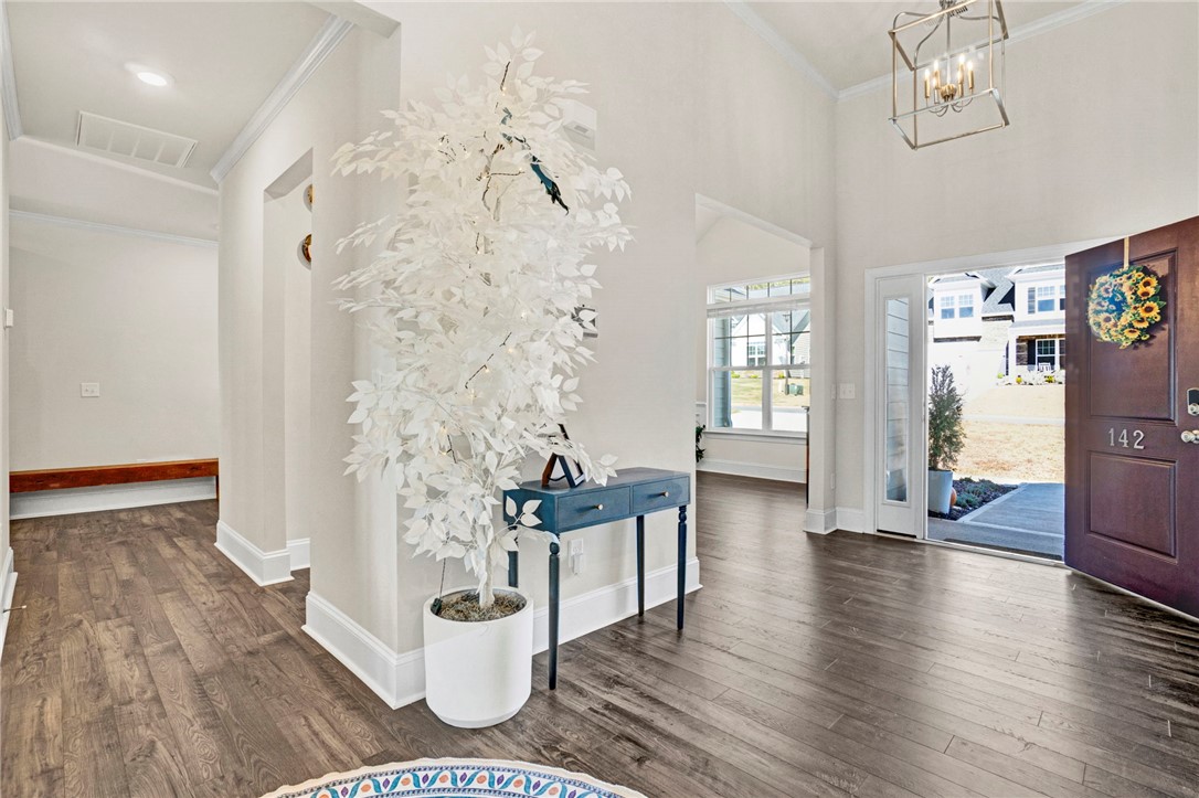 142 Juniper Hill Drive Easley, SC 29642 - Photo 5 of 47 Enter into a bright foyer with vaulted ceilings and beautiful wood flooring.