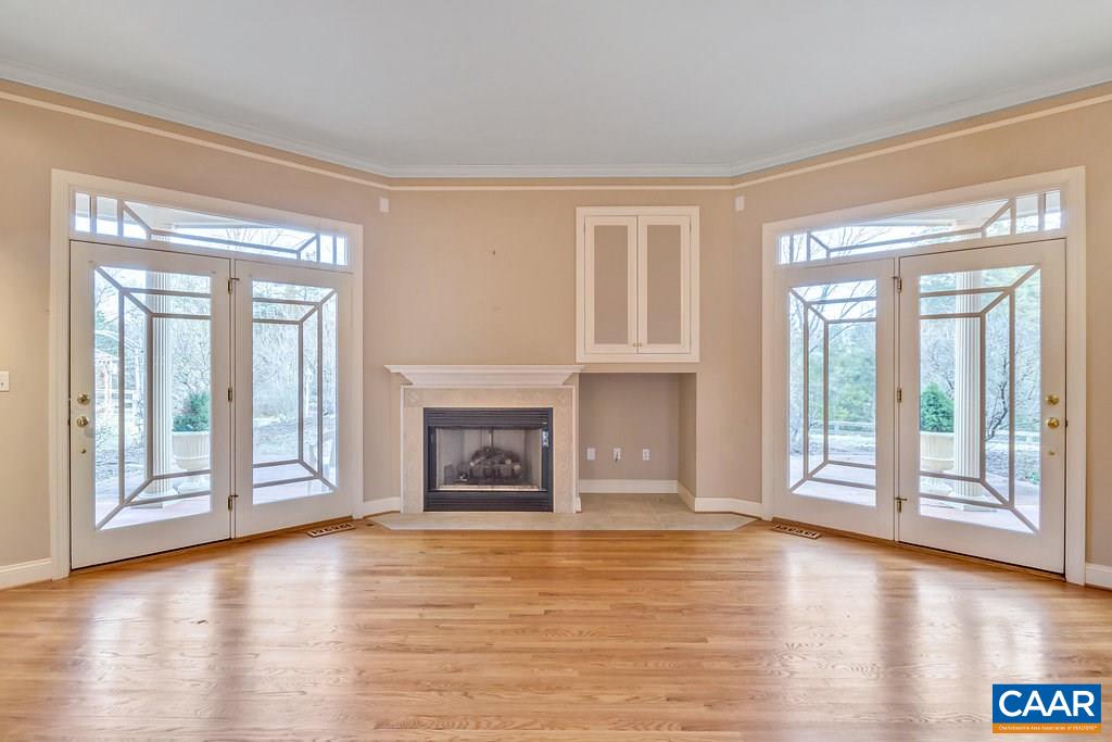 4460 Ivy Road Charlottesville, VA 22903 - Photo 6 of 26 The doors let in lots of natural light while providing access to the rear patio. Fireplace is gas now and was designed to be that or wood.