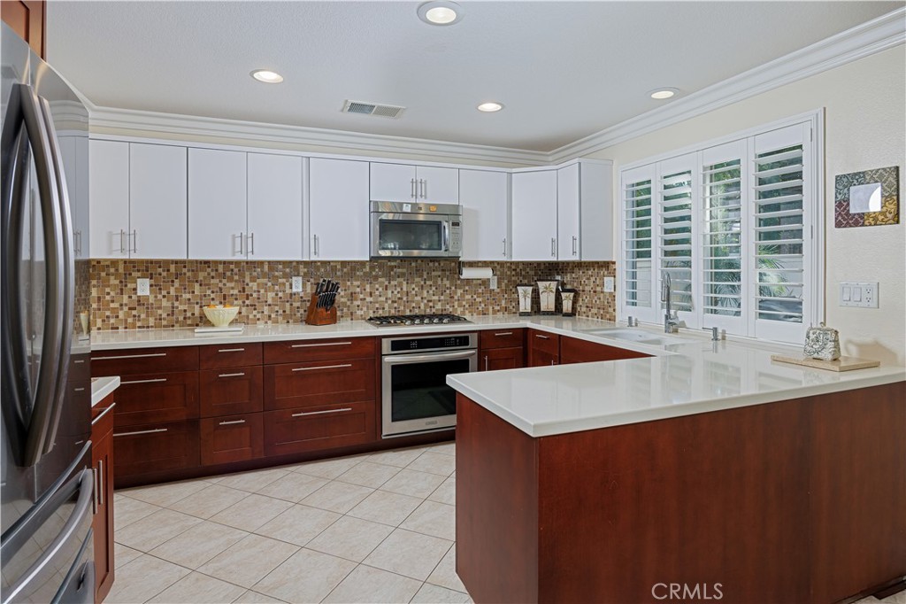 14 Sorenson Irvine, CA 92602 - Photo 13 of 29 a kitchen with stainless steel appliances granite countertop a sink counter space cabinets and a large window
