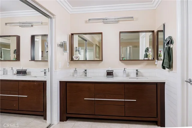 a bathroom with a double vanity sink and mirror