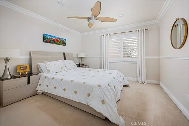 a bedroom with a bed a dresser and a window