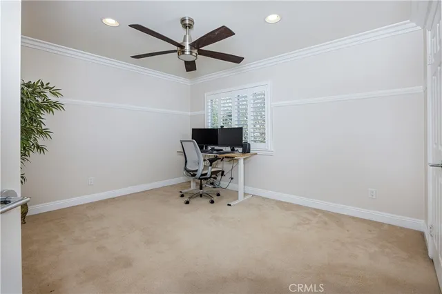 a view of workspace with chair and ceiling fan