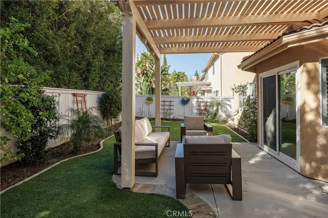 a view of a porch with furniture and a yard
