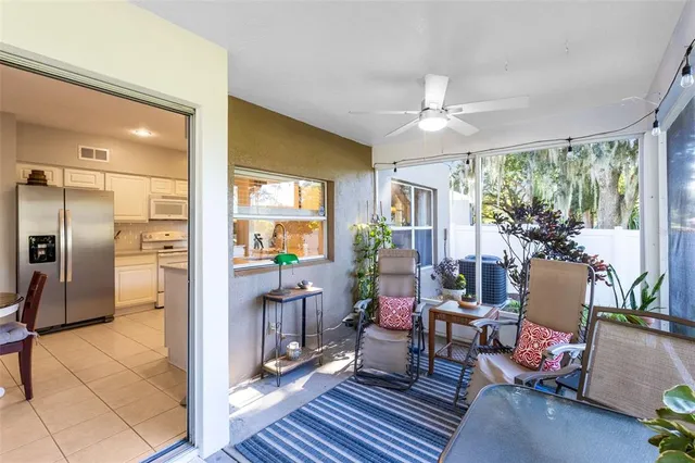 a living room with furniture a fireplace and a chandelier