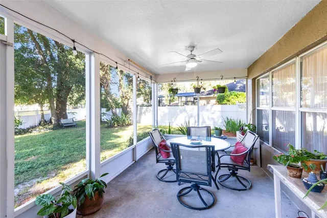 a dining room with furniture water view and a floor to ceiling window