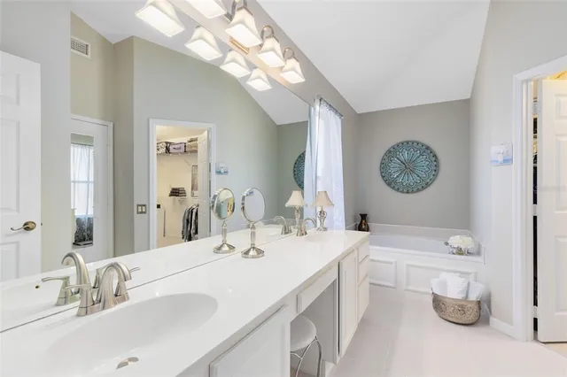 a bathroom with a double vanity sink and a mirror