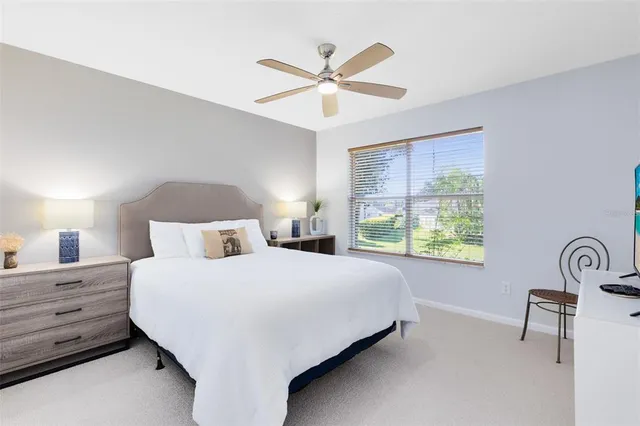 a bedroom with a bed a window and mirror