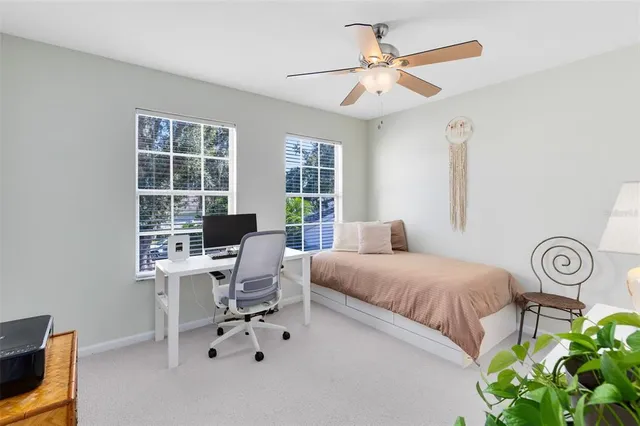 a bedroom with a bed table and a window