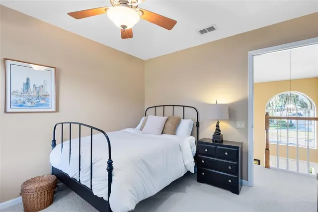 a bedroom with a bed and a large window