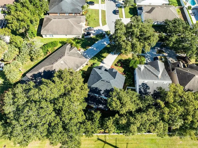 an aerial view of a house with a yard
