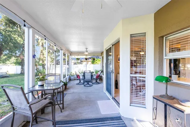 a living room with furniture and large windows