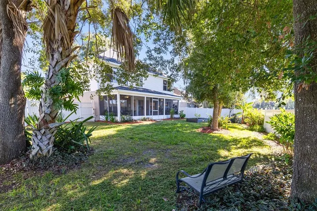 a view of a house with backyard and sitting area