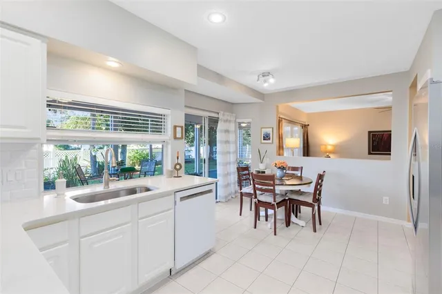a dining room with furniture and a large window